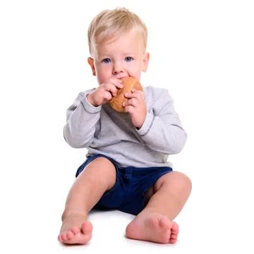 Baby eats bread Stock Photos