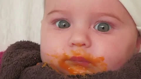 Baby eats carrot for the first time Stock Footage 11927139