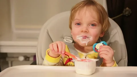 Baby eats cottage cheese Stock Footage 147168910