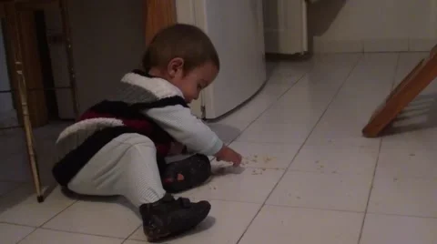 Baby eats crackers from the floor 3, Crystal child Stock Footage 47546278