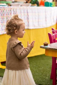 A baby eats a cupcake. Stock Photos