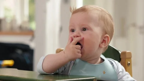 Baby eats food in pieces Stock Footage 310521934