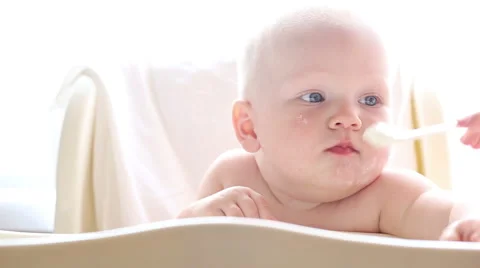 Baby eats a highchair closeup Stock Footage 40760840
