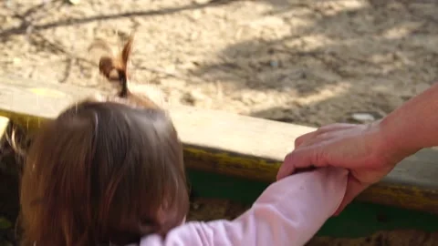 Baby eats sand but was prevented from stopped Stock Footage 138682307