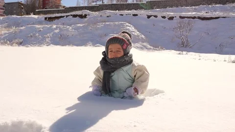 Baby experiences ice for the first time. Child wearing warm winter clothes. Stock Footage 232208167