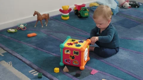 Baby exploring sorting toy Stock Footage 311781066