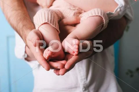 Baby feet in father hands Stock Photos