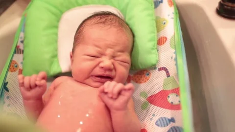 Baby First Bath at Home in Sink Stock Footage 85374516