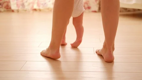 Baby first step with mother Stock Footage 128038501