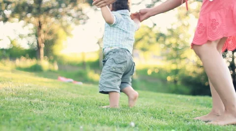 Baby first steps on grass, dolly shot Stock Footage 5229355