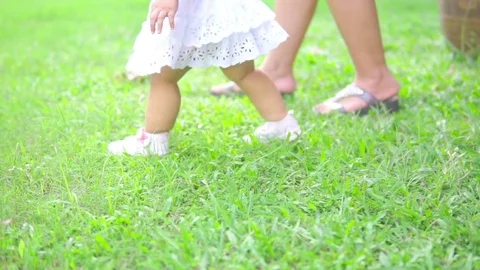 Baby first steps on grass Stock Footage 76113595