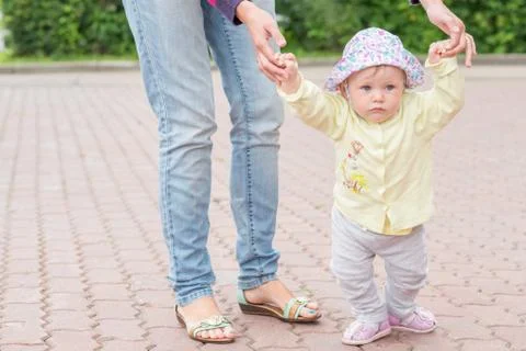 Baby first steps with mom Stock Photos