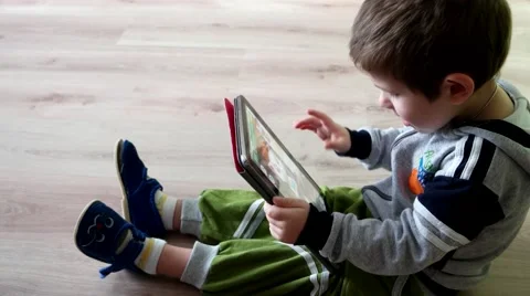 BABY on the floor plays with a virtual cat on a large touch screen Stock Footage 59963894
