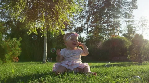 Baby Girl Grass Bubble Burst Arm - 4k - Slow motion Video stock 61103953
