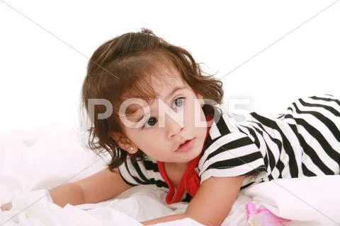 Baby girl lying on the bed with swimsuit with space for advertising Stock Photos