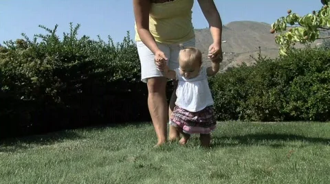 Baby Girl walking outside with mom Stock Footage