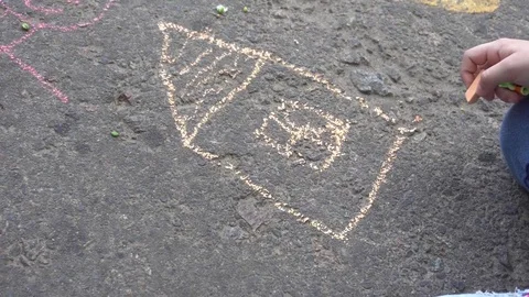 Baby hand drawing with colored chalks on the pavement Stock Footage 76214145