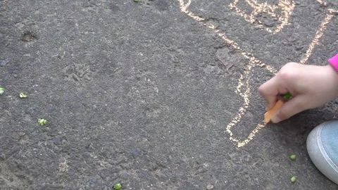 Baby hand drawing with colored chalks on the pavement Stock Footage 76214188