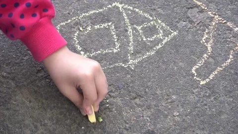 Baby hand drawing with colored chalks on the pavement Stock Footage 76214225