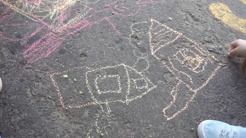 Baby hand drawing with colored chalks on the pavement Stock Footage 76214252