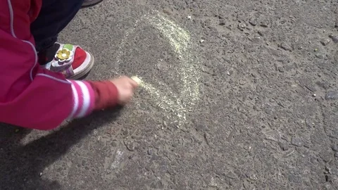Baby hand drawing with colored chalks on the pavement Stock Footage 76214972