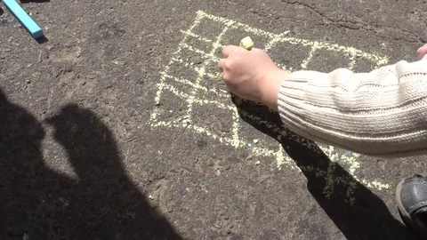 Baby hand drawing with colored chalks on the pavement Stock Footage 76215115