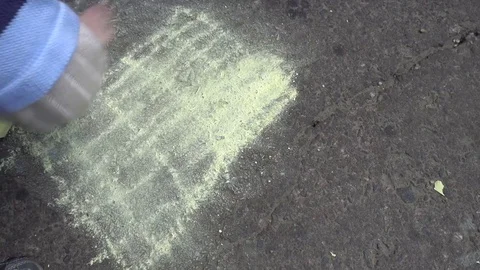 Baby hand drawing with colored chalks on the pavement Stock Footage 76215201