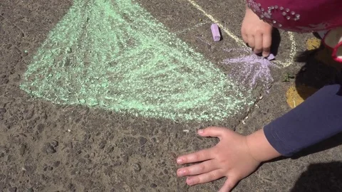 Baby hand drawing with colored chalks on the pavement Stock Footage 76215313