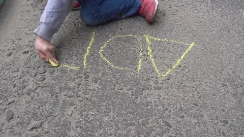 Baby hand drawing with colored chalks on the pavement Stock Footage 76215339