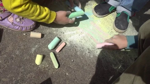 Baby hand drawing with colored chalks on the pavement Stock Footage 76215420