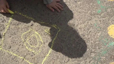 Baby hand drawing with colored chalks on the pavement Video stock 76215436