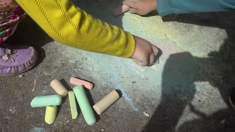Baby hand drawing with colored chalks on the pavement Stock Footage 76215467