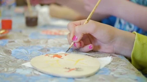 Baby hand paint traditional Easter egg, closeup. Video stock 74619587
