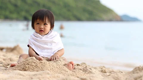 Baby happy playing on the beach Stock Footage 32153247