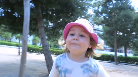 Baby with hat running in park Stock Footage 65102783