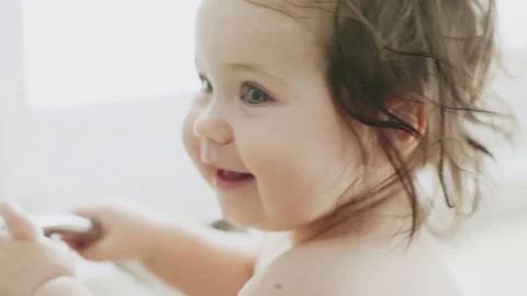 Baby having a bath in the kitchen sink Stock Footage 79796639