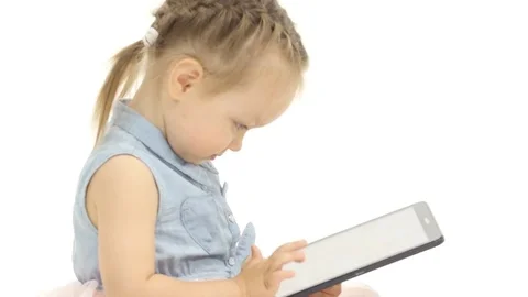 Baby is holding a computer in her hands and cliches, she is in a good mood Vidéo 76745311