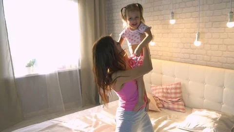 Baby hugging with mom in bed Stock Footage 74002105