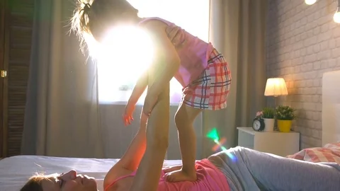 Baby hugging with mom in bed Stock Footage