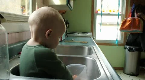 Baby in the kitchen sink Video stock 9806450