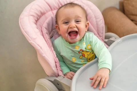 Baby laughs while being feeded Foto stock