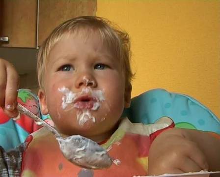 Baby learning to feed himself  Stock Footage 513810