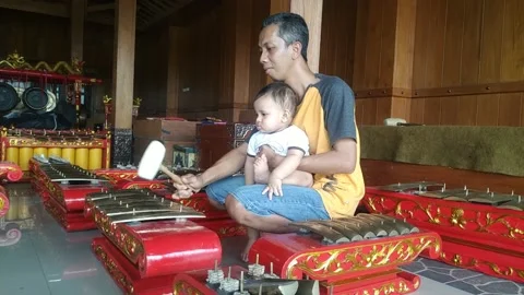 Baby learning gamelan Stock Footage 160901817