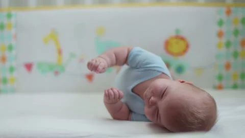 Baby learning to roll over by herself. Stock Footage 170939959
