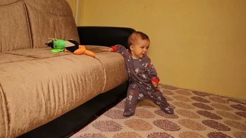 Baby learning to stand up. learn to walk. Happy family. Newbaby, infant. Kids Stock Footage 210736905