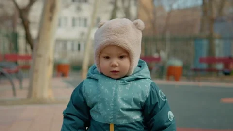 Baby learning to walk in playground Video stock 303577957