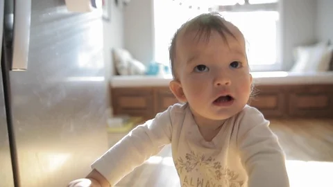Baby Learning to Walk in Slow Motion Stock Footage 122839623