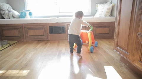 Baby Learning to Walk in Slow Motion Stock Footage 122840233