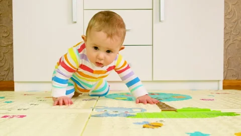 Baby learns to crawl. selective focus. Stock Footage 151349364