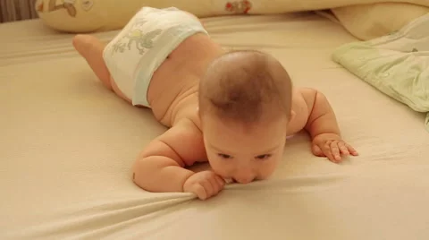Baby lie stomach play Stock Footage 59776079